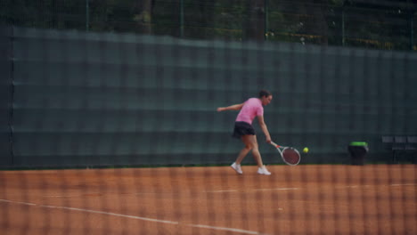 tennis-net-on-the-court-in-slow-motion-on-the-background-of-a-woman-playing-a-batting-ball